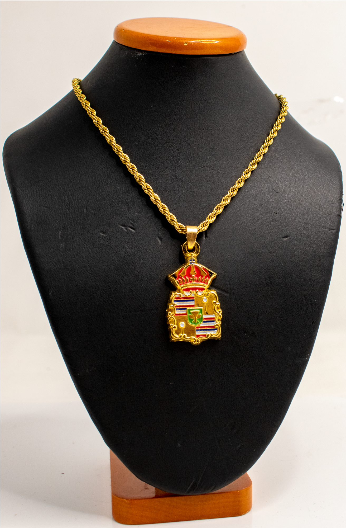 Introducing our Hawaiian Royal Crest pendant. Symbolizing power and heritage, our chain showcases intricate design elements from Hawaiian culture - kahili, spears, and the crown, mirroring the Hawaiian's rich royal history. Each chain wearer captures the authority and connection to the land, and royalty offering wearers a chance to embody the strength and prestige of Hawaiian monarchy. This symbol is important for our and all Hawaii clothing brands.